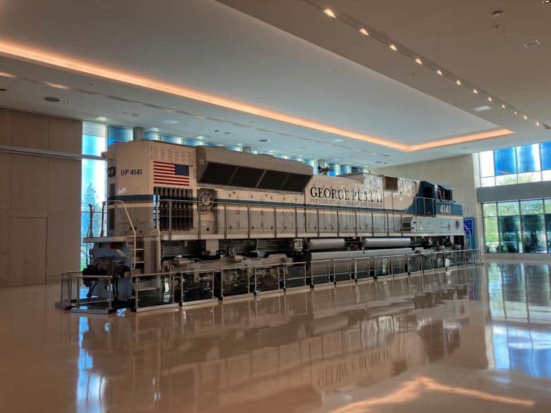 Iconic train engine exhibit highlighting electrical system installation and museum lighting.