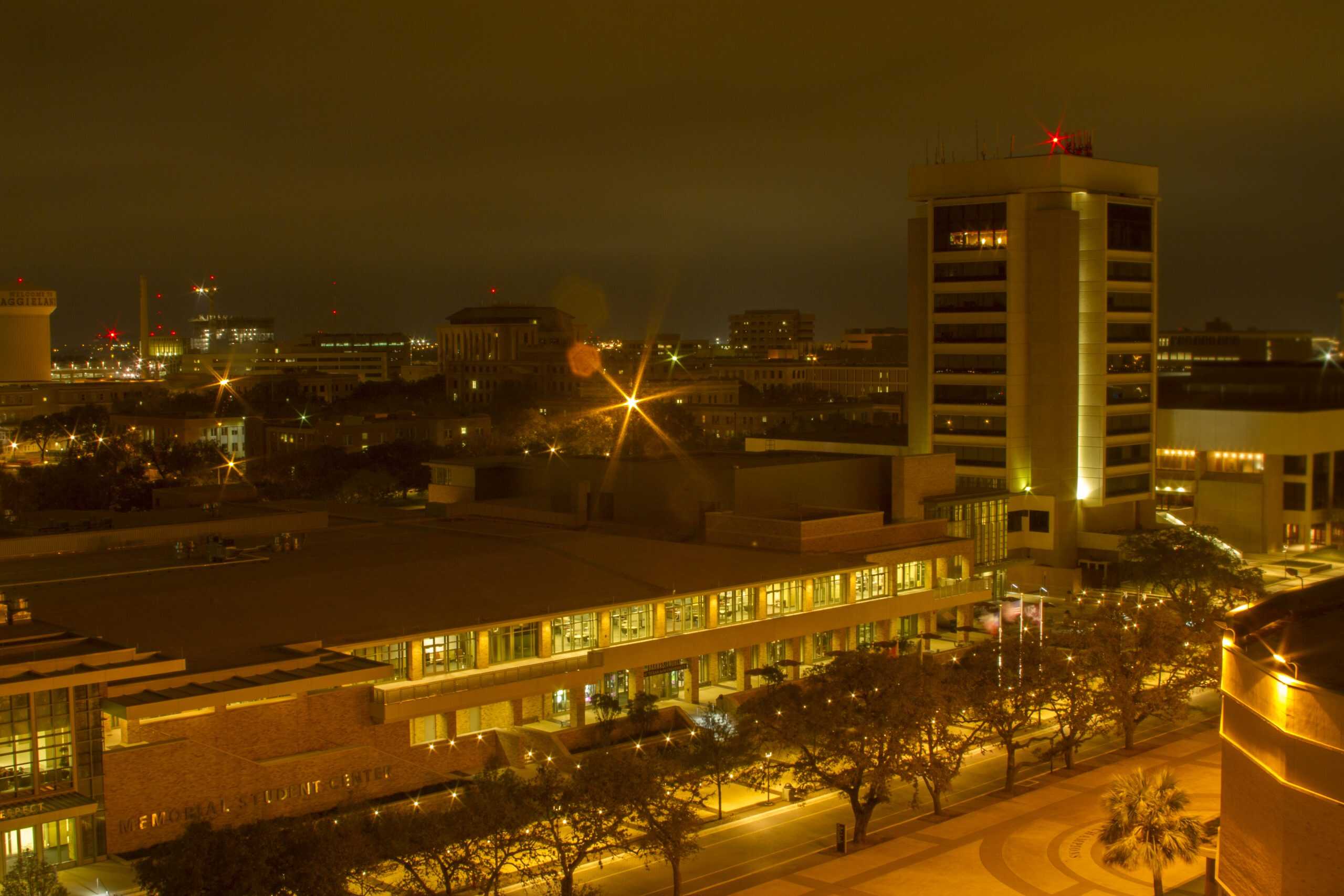 Bright urban night scene with well-lit structures and city lights at night.