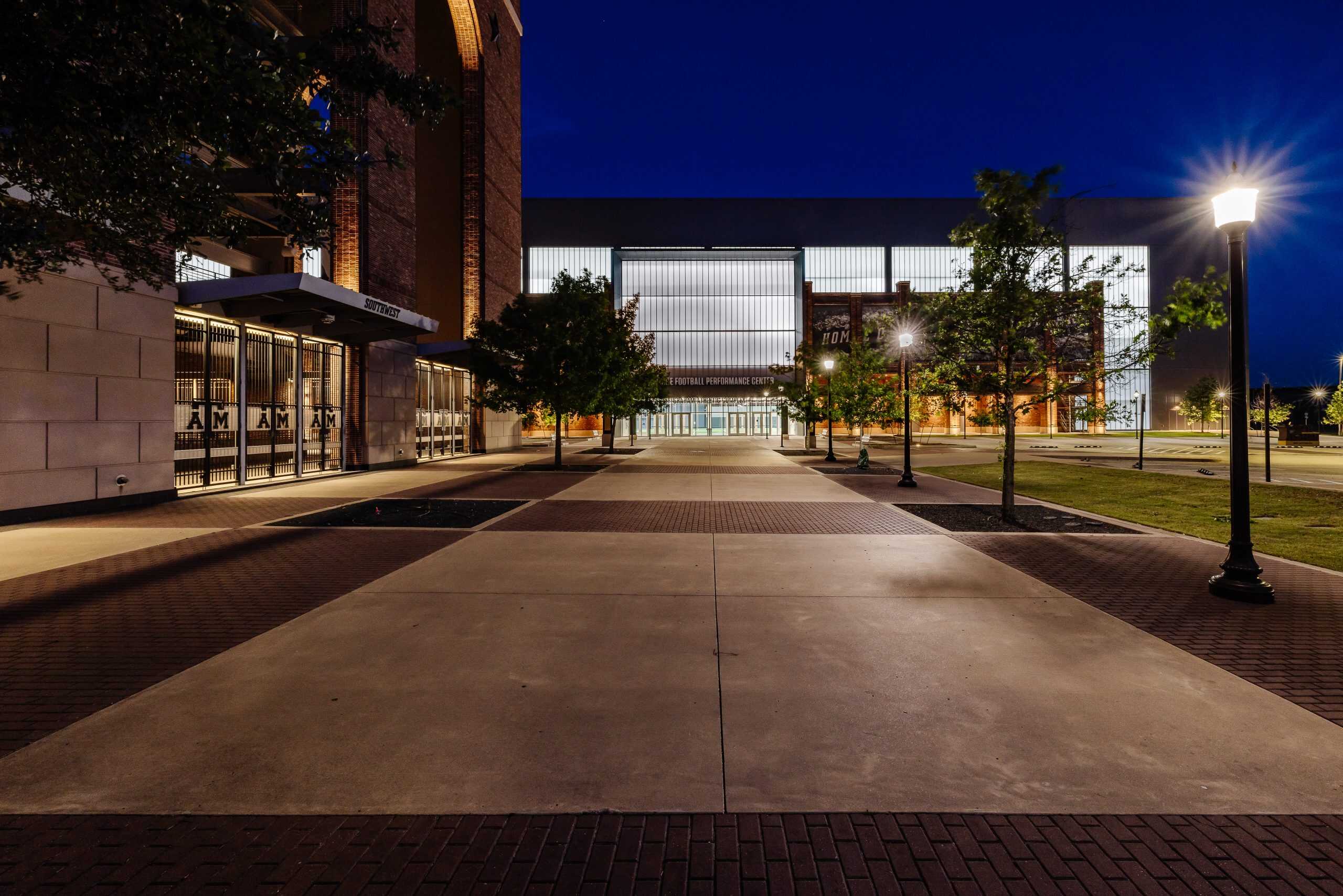 Exterior nighttime view of a stadium with professional lighting, highlighting electrical installation and outdoor lighting solutions.